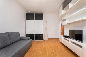 a living room with a couch and a flat screen tv at Anielewicza 49 by Homeprime in Warsaw +5 photos
