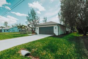 a house with a garage and a driveway at The Basilican in Cape Coral