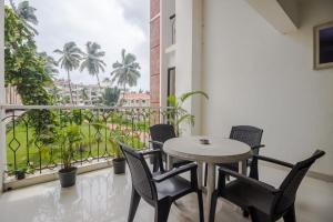 a table and chairs on a balcony with a view at 3/4bhk luxury space with pool in Candolim