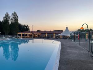 a large swimming pool next to a building at Natura Resorts in Casalarreina