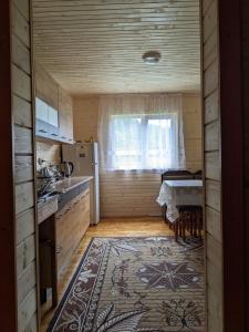 een kleine keuken met een tafel en een raam bij Na Hutori in Tatariv
