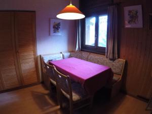 a dining room table with a purple table cloth on it at Ferienwohnung Interlaken/Wilderswil in Wilderswil