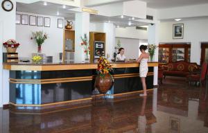a woman standing at a counter in a salon at Corallia Beach Hotel Apartments in Coral Bay