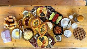 a wooden table with plates of food on it at Guest house Nataly in Yeghegnadzor