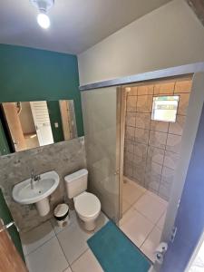 a bathroom with a toilet and a sink and a shower at Free! Hostel Vila in Pipa
