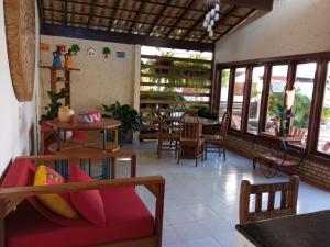 a living room with a couch and a table at Pousada Vila Morena in Itaúnas
