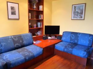 ein Büro mit 2 blauen Stühlen und einem Schreibtisch in der Unterkunft Apartment Lido in Gozzano