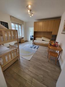 a bedroom with two bunk beds and a table at Big appartement - 9 guests - 30 min from ski stations in Bussoleno