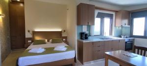 a small kitchen with a bed in a room at Romantica Apartments in Falasarna