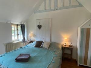 a bedroom with a large bed with a tray on it at Gite des Trévignes in Cambremer