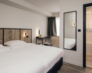 Postel nebo postele na pokoji v ubytování Hotel Au lit des ours