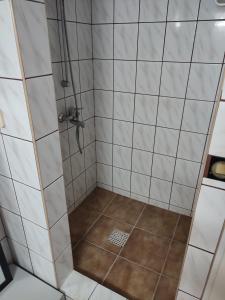 a bathroom with a shower with white tiles at Łapu Capu - Mieszkanie dla 4 osób in Grajewo