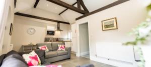 a living room with a couch and a table at The Barn at Meadow Farm in Derby