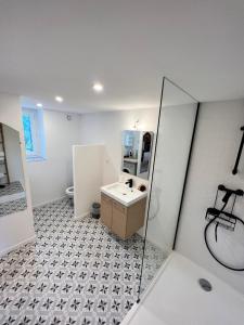a white bathroom with a sink and a mirror at Mas Thomasine Séjour Romantique au calme in Peillon