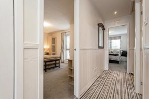 a hallway with a door leading to a bedroom at Penthouse Seafront Largs in Largs