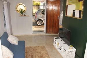 a living room with a car parked in a driveway at Adorable 1.5 -Bedroom flatlet in Germiston in Germiston