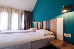 Postel nebo postele na pokoji v ubytování Wine Rock Hotel