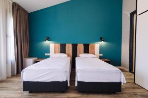 Postel nebo postele na pokoji v ubytování Wine Rock Hotel