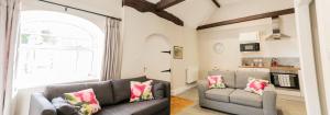 a living room with two couches and a window at The Barn at Meadow Farm in Derby