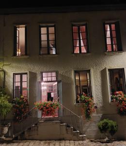 a building with stairs and flowers in front of it at SUPREMATISME Appartement de Prestige in Vierzon