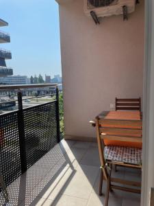 a table and chair on a balcony with a view at Apartment Jelena in Zagreb