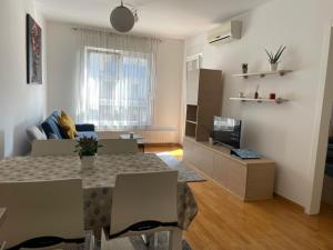 a living room with a table and a couch at Apartment Jelena in Zagreb