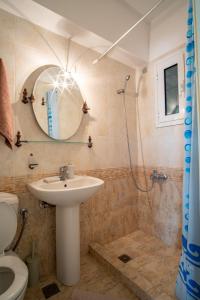 a bathroom with a sink and a shower at Erifili Luxury Apartment in Samos