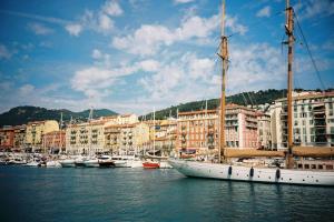 a group of boats docked in a harbor with buildings at Mas Thomasine Séjour Romantique au calme in Peillon