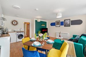 a kitchen and living room with a table and chairs at 30 percent OFF! Emerald 3 Bed Gem in Southampton in Totton