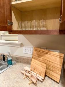 a kitchen counter with a wooden cutting board on the floor at Lovely Townhouse! in Auburn