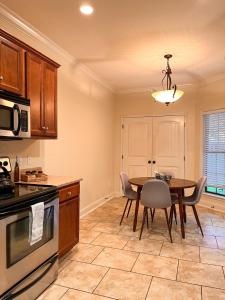 a kitchen with a table and a dining room at Lovely Townhouse! in Auburn