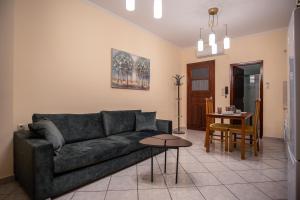 een woonkamer met een bank en een tafel bij Ariadni Luxury Apartment in Samos