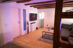 a living room with a couch and a table at WINETIME - modern - für 6 - Boxspringbetten - zentral in Bellheim