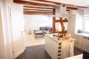 a kitchen and living room with a couch at WINETIME - modern - für 6 - Boxspringbetten - zentral in Bellheim