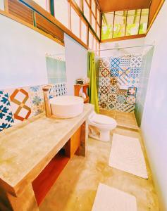 a bathroom with a sink and a toilet at Kinkajoungalows - Amaya Family, Drake Bay, Osa Peninsula in San Pedrillo