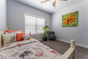 a bedroom with a bed and a window at Nest - a cheerful 4 bedroom, 4.5 bath new townhome in Aggieland in College Station