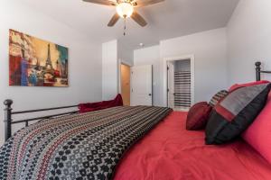 a bedroom with a bed and a ceiling fan at Nest - a cheerful 4 bedroom, 4.5 bath new townhome in Aggieland in College Station