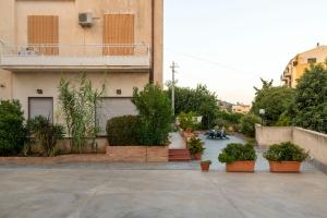 a building with potted plants in front of it at Casa Raffaela in Modica
