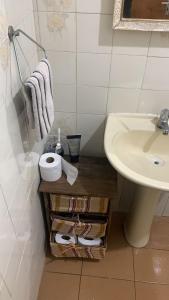 a bathroom with a sink and a counter with a towel at VILLA PRAIA GRANDE in Matinhos +18 photos