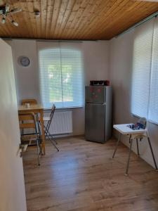 a kitchen with a refrigerator and a table and chairs at (Ferien-)Wohnung im schönen Fichtelgebirge in Marktredwitz +25 photos