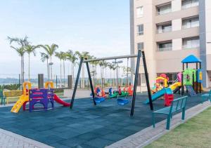 a playground with colorful playground equipment in front of a building at Resort Solar das Águas in Olímpia