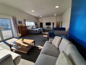 a living room with a couch and a table at Pukaki Air Lodge in Twizel