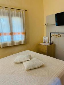 a bedroom with a bed with two pillows on it at Il Nuraghe del lago Coghinas in Oschiri