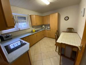 a small kitchen with a table and a table and a table and a tableearcher at Ferienwohnung Suhad in Ludwigshafen am Rhein