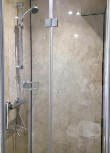 a shower with a glass door in a bathroom at Skye View-Skye Bridge House in Kyle of Lochalsh