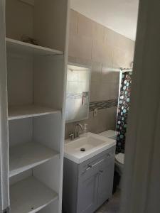 a white bathroom with a sink and a mirror at Home Sweet Home in Colton