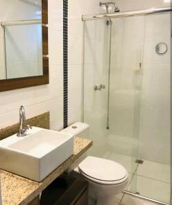 a bathroom with a sink and a toilet and a shower at Apartamento Executivo - No melhor lugar do América in Joinville
