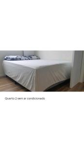 a bed in a room with at Apartamento Executivo - No melhor lugar do América in Joinville