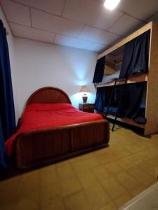 a bedroom with a bed and two bunk beds at OliWine hostel in Maipú