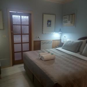 a bedroom with a bed with two towels on it at Mount View Motel in Bulahdelah